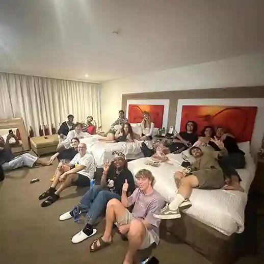 Jhon Standleey sitting on floor with all top 12 contestants